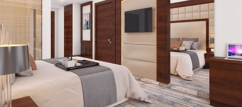 A cozy room with a king-size bed, wall-mounted television, and warm lighting at BluSalzz Residence, Amritsar.